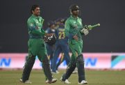 shoaib Malik and his teammate Iftikhar Ahmed walk off the field