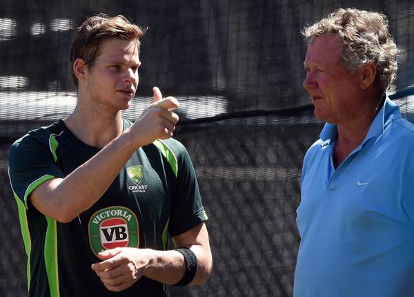 Australian cricketer Steve Smith interacts with former captain Kim Hughes during a training session in Adelaide on March 19, 2015, ahead of the 2015 Cricket World Cup quarter-final match between Australia and Pakistan. AFP PHOTO / INDRANIL MUKHERJEE -- IMAGE RESTRICTED TO EDITORIAL USE - STRICTLY NO COMMERCIAL USE-- (Photo credit should read INDRANIL MUKHERJEE/AFP/Getty Images)