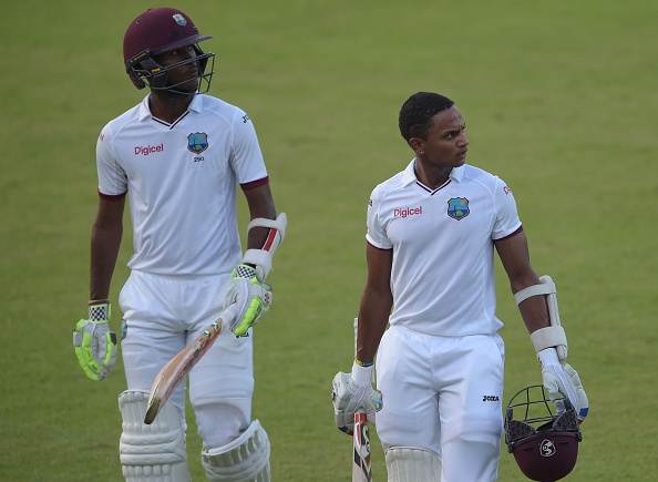 West Indies' batsmen Kraigg Brathwaite (L) and Shane Dowrich walk back to the pavilion. (Photo by AAMIR QURESHI/AFP/Getty Images)