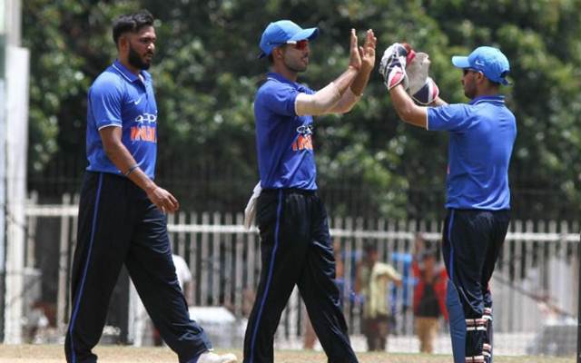 Indian Board President’s XI players celebrate a fall of a wicket in the warm-up game against Australia