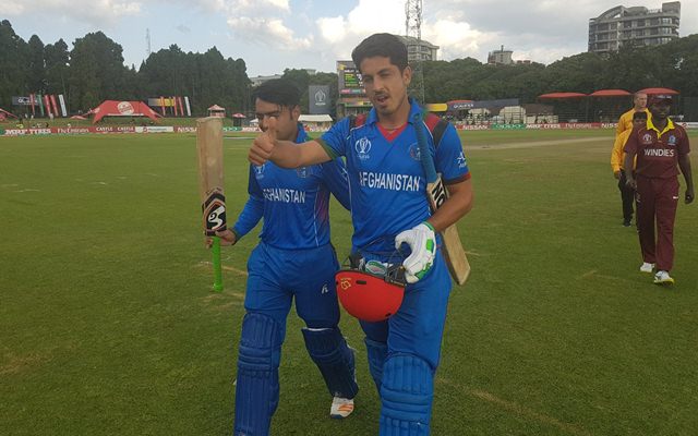 Sharafuddin Ashraf and Rashid Khan leave the field after the victory