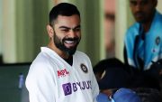 Virat Kohli of India shares a joke with teammates from the dressing room.